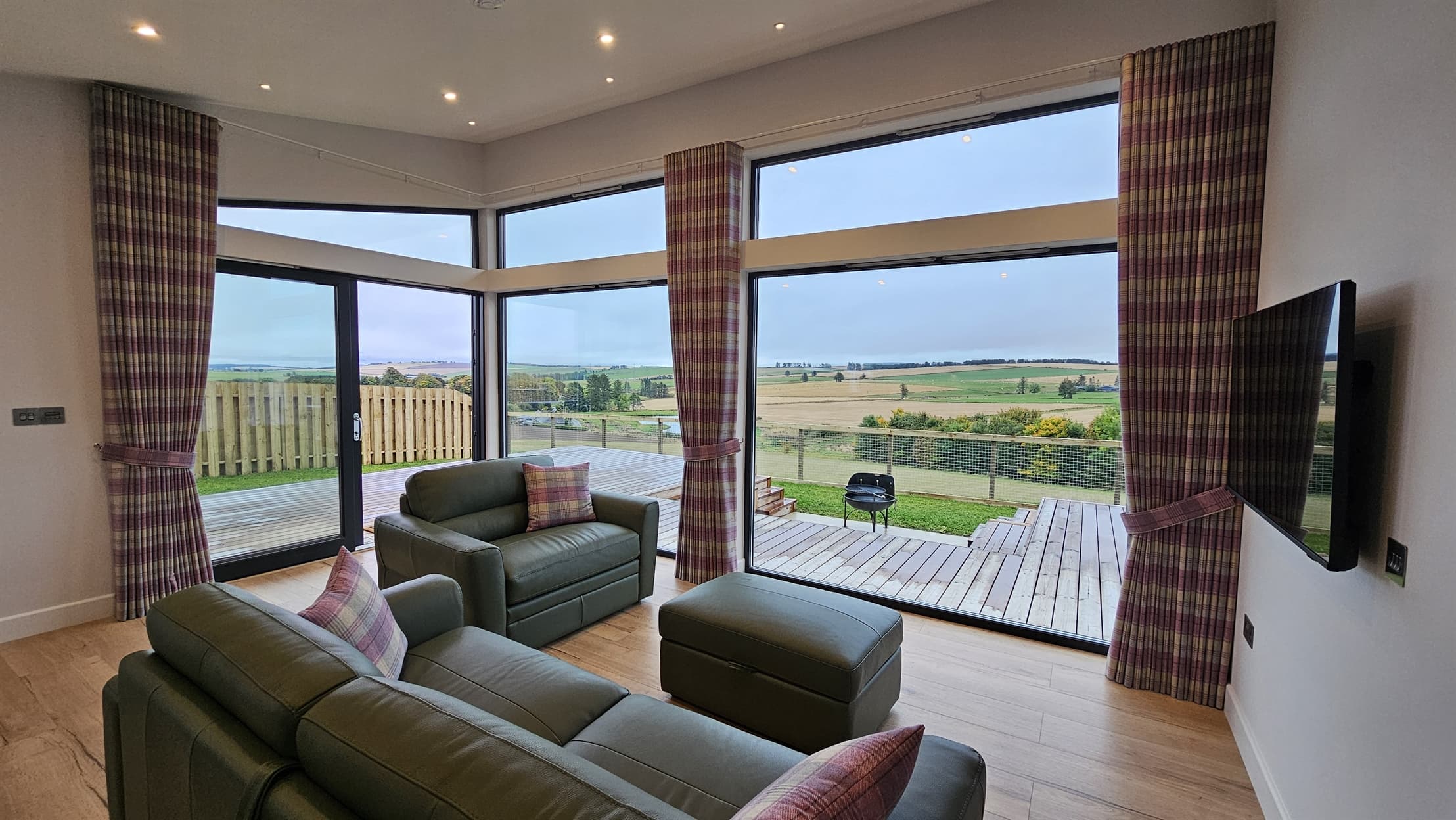 Spacious living room with floor to ceiling windows overlooking stunning views