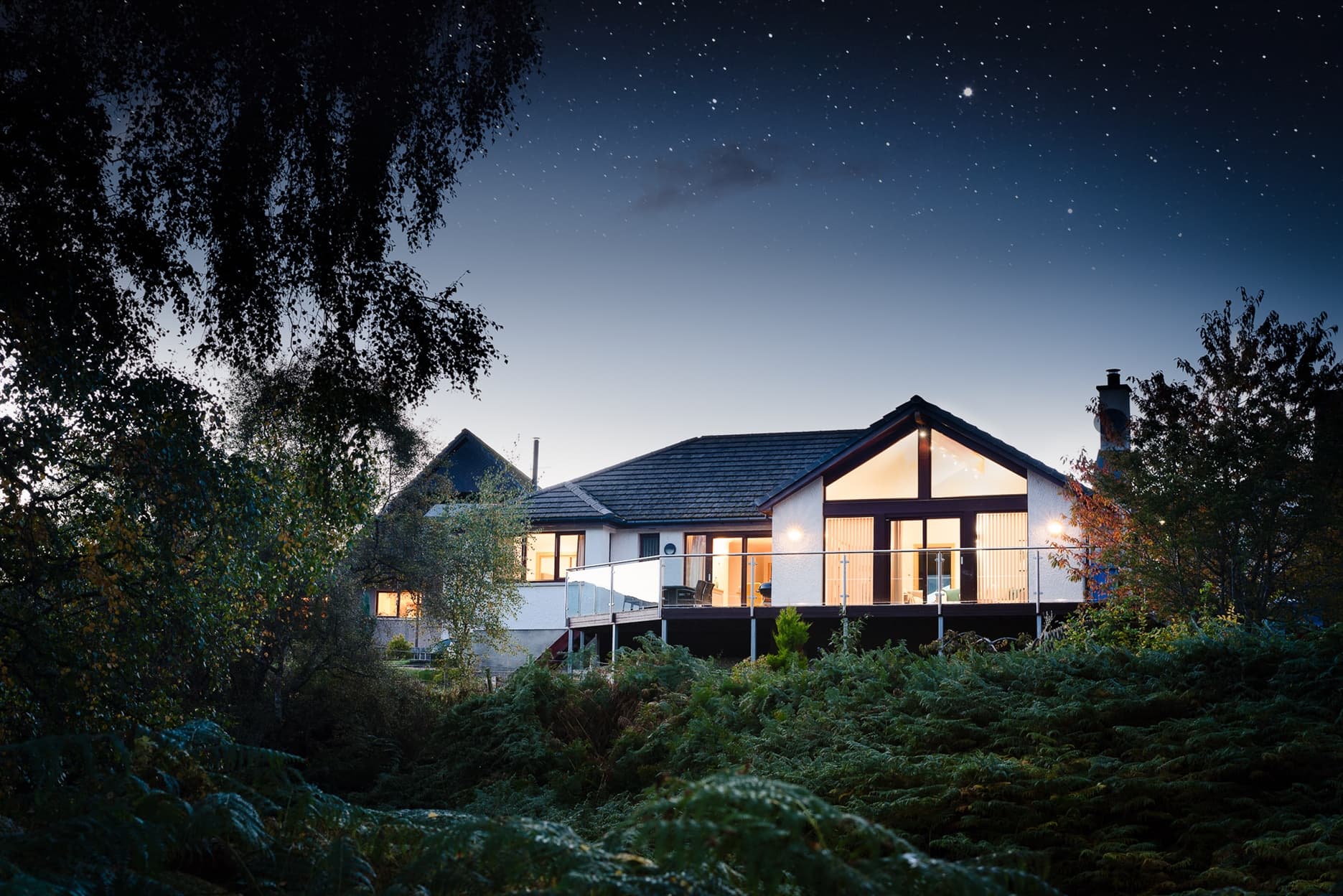 The outside of Coorie Lodge in the evening twilight.