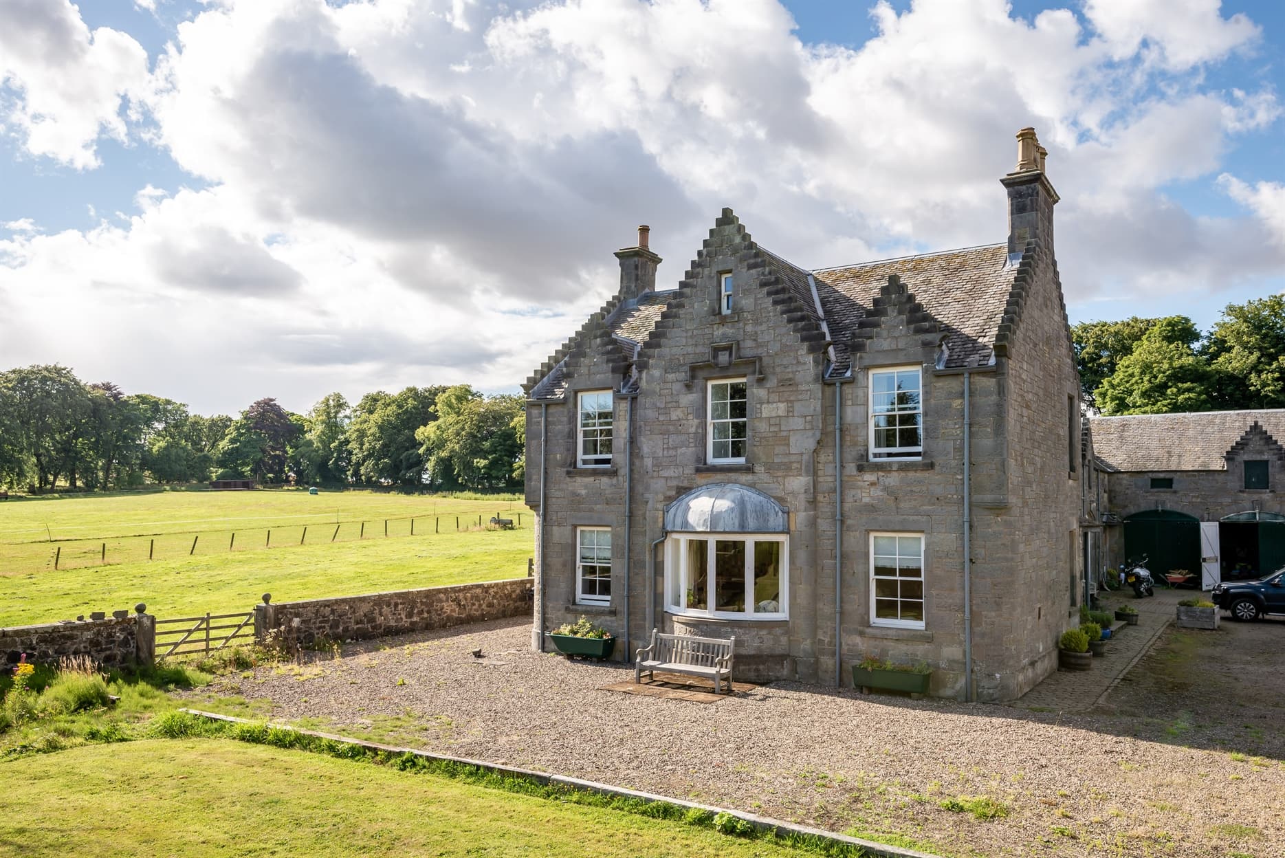 Montrave House, sleep up to 7 people. A large stone building with slate roof and cross step gables set in rural location, part of an old stable comple